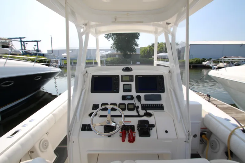 Slide: The Image of The image shows the cockpit of a 2010 Regulator 34SS boat with modern navigation systems. - 18