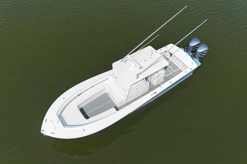 Slide: The Image of Aerial view of a white 2010 Regulator 34SS boat on calm water. - 4