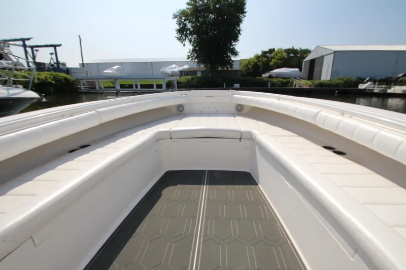 Slide: The Image of The image shows the bow area of a 2010 Regulator 34SS boat with white upholstery. - 14