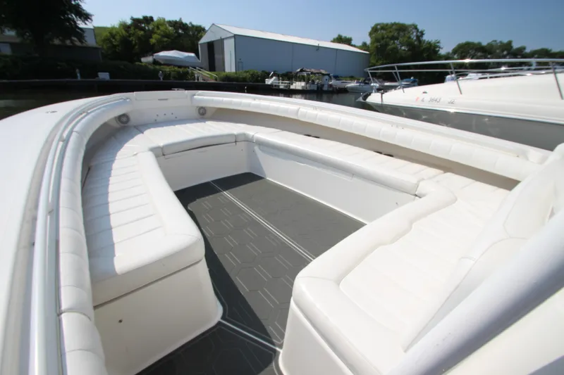 Slide: The Image of The image shows the spacious cockpit of a Regulator 34SS boat with white cushioned seating. - 12