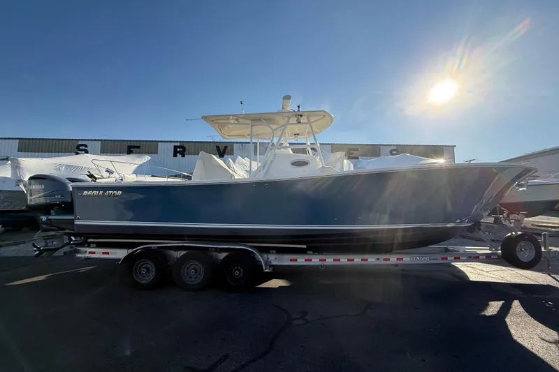 Slide: The Image of 2010 Regulator 34SS boat on trailer under bright sun. - 36