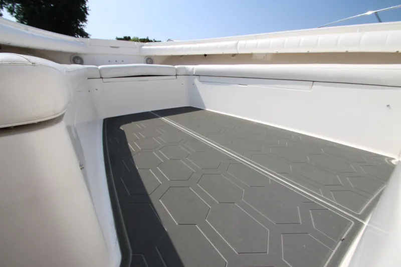 Slide: The Image of The image shows the spacious cockpit of a 2010 Regulator 34SS boat with gray flooring. - 13