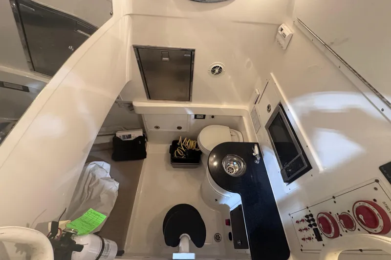 Slide: The Image of 2010 Regulator 34SS boat interior with sink, toilet, and control panel. - 31