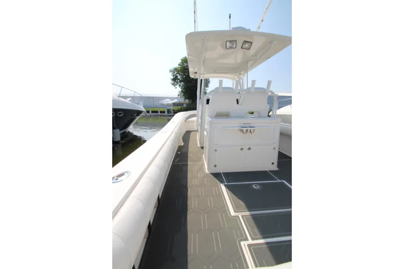 Slide: The Image of The image shows the deck of a 2010 Regulator 34SS boat with a central helm station. - 24