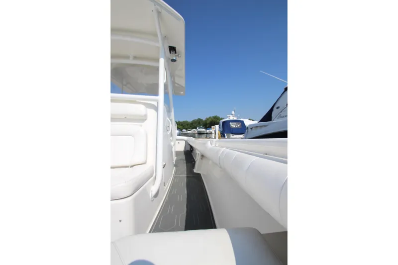 Slide: The Image of A 2010 Regulator 34SS boat with white interior and side deck, docked at a marina. - 17