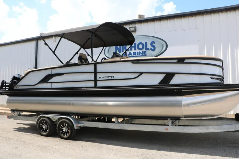 Slide: The Image of 2026 Evotti 725QL pontoon boat on trailer at Nichols Marine dealership. - 2