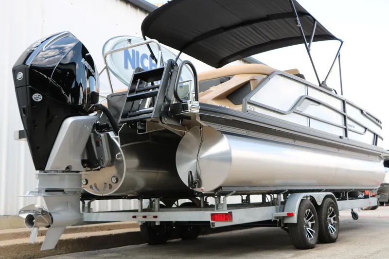 Slide: The Image of Evotti 725QL 2026 pontoon boat on trailer, featuring sleek design and powerful outboard motor. - 13