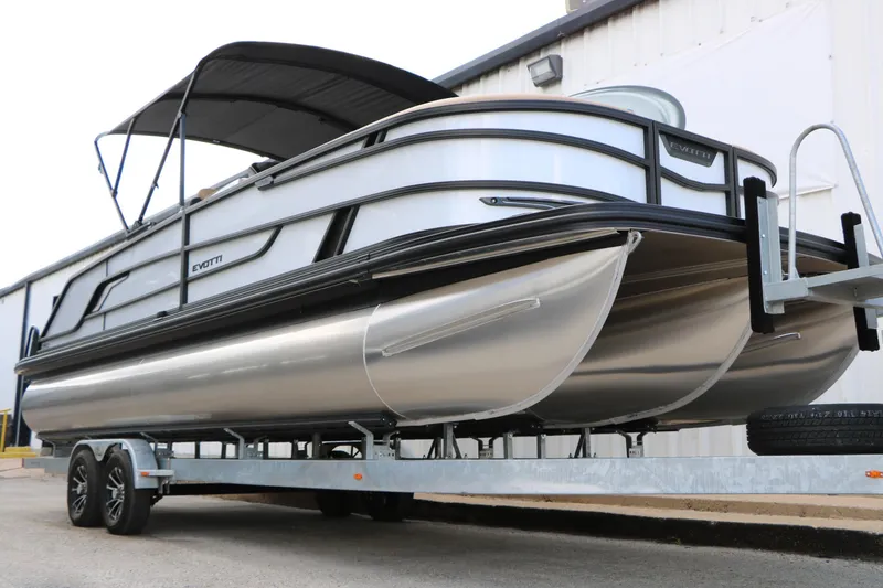 Slide: The Image of 2026 Evotti 725QL pontoon boat on trailer, featuring sleek design and modern canopy. - 7