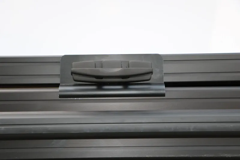 Slide: The Image of Evotti 725QL 2026 model roof rack clamp in black, close-up view. - 15
