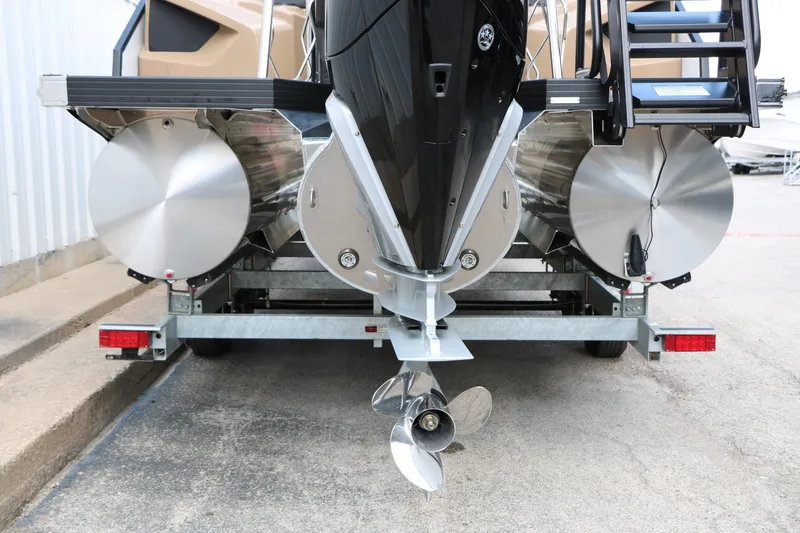 Slide: The Image of Rear view of 2026 Evotti 725QL boat on trailer, showcasing propeller and pontoons. - 19