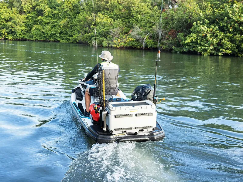 Slide: The Image of An angler rides a Sea-Doo FishPro Sport 170 through calm waters, surrounded by lush greenery. - 10