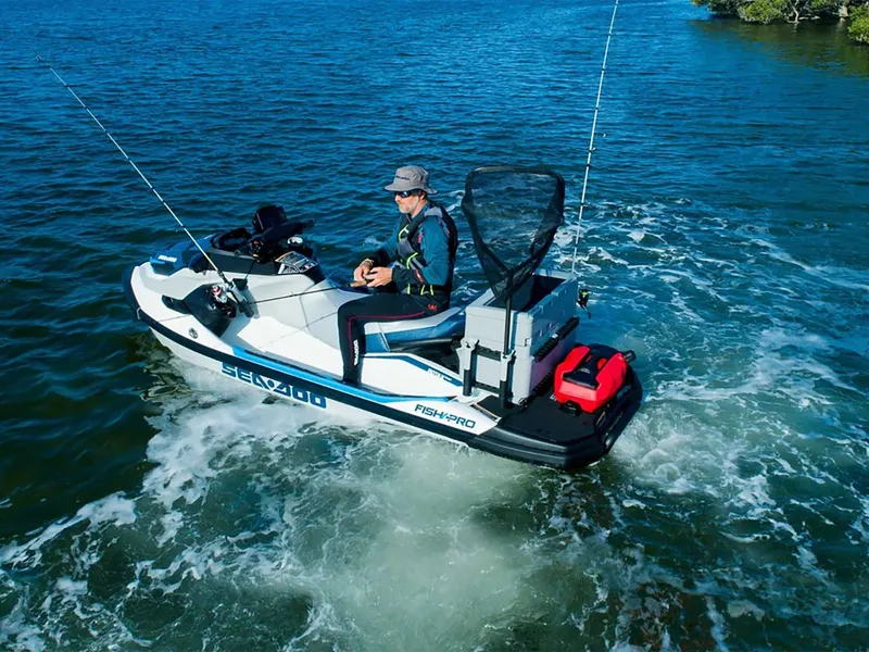 Slide: The Image of An angler sits on a Sea-Doo FishPro Sport 170 in the water, surrounded by fishing rods. - 11