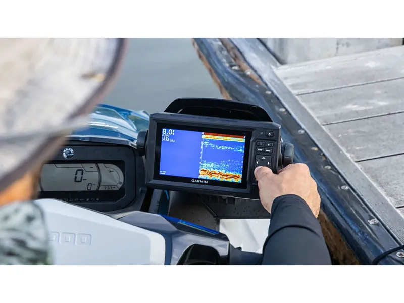 Slide: The Image of A person operates a Garmin fish finder display on a Sea-Doo watercraft next to a dock. - 4