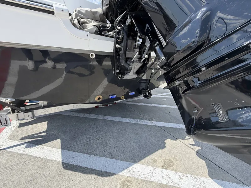 Slide: The Image of A black outboard motor is mounted on a white boat, which is on a trailer. - 10