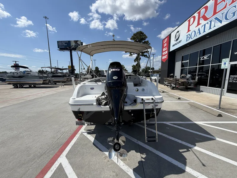 Slide: The Image of A 2018 Hurricane 201 SS boat with an outboard motor, parked in a lot. - 9