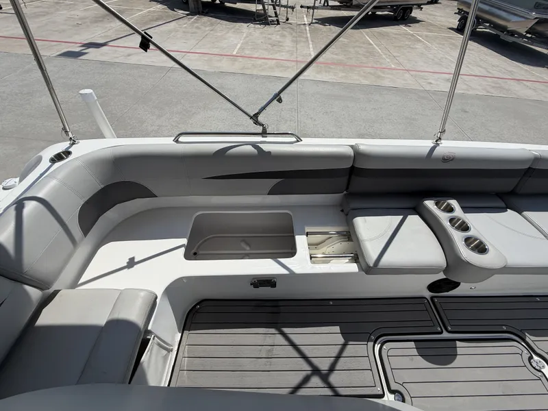 Slide: The Image of The image shows the cockpit of a 2018 Hurricane 201 SS boat with gray upholstery and cup holders. - 21