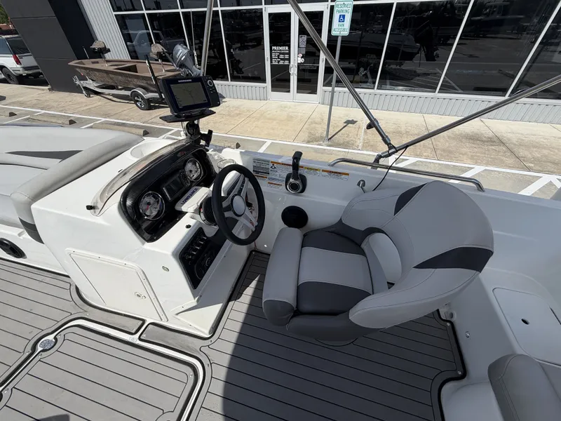 Slide: The Image of The image shows the cockpit of a 2018 Hurricane 201 SS boat with a helm and cushioned seat. - 14