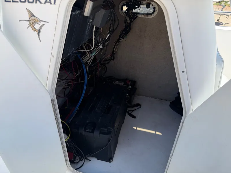 Slide: The Image of A view inside the storage area of a 2002 PRO SPORT PRO KAT 2200 boat with cables and equipment. - 19