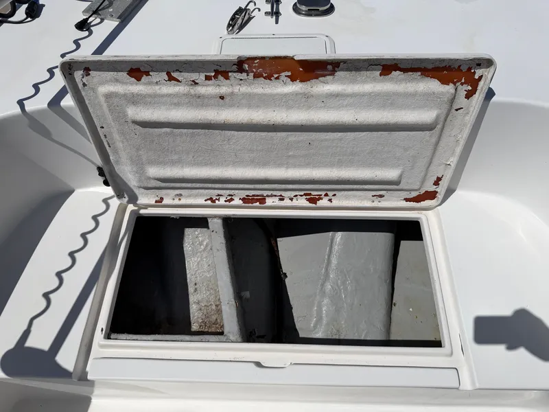 Slide: The Image of An open storage compartment on a boat with peeling paint on the lid's edge. - 16