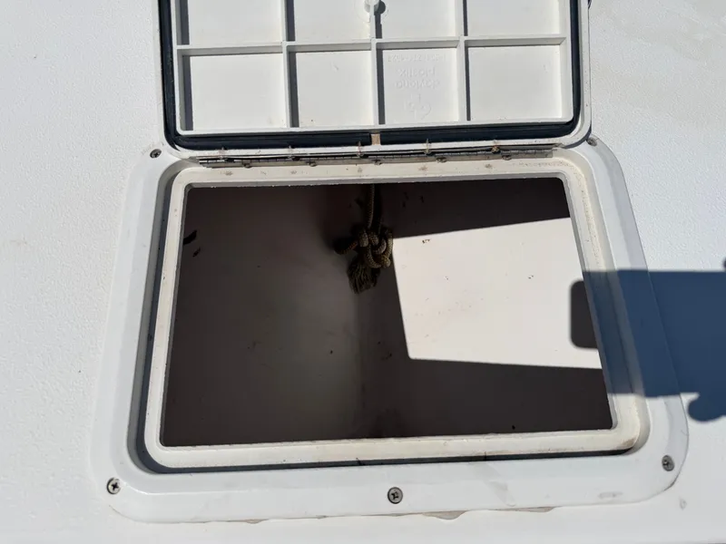 Slide: The Image of An open storage compartment on a boat with a rope inside. - 15