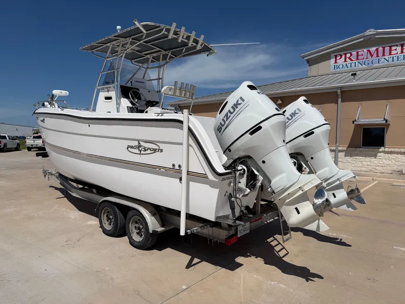 Slide: The Image of A white 2002 PRO SPORT PRO KAT 2200 boat with twin Suzuki outboard engines on a trailer. - 10