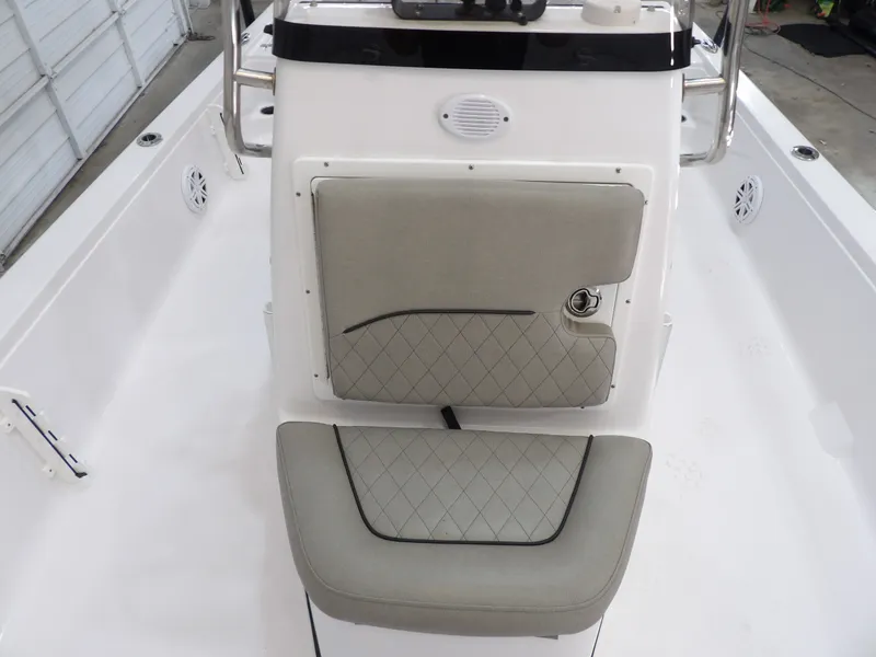 Slide: The Image of The image shows the helm of a 2022 Sportsman Tournament 214 Bay Boat with cushioned seating. - 13