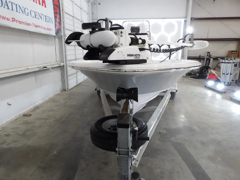 Slide: The Image of A 2022 Sportsman Tournament 214 Bay Boat is on a trailer inside a warehouse. - 6