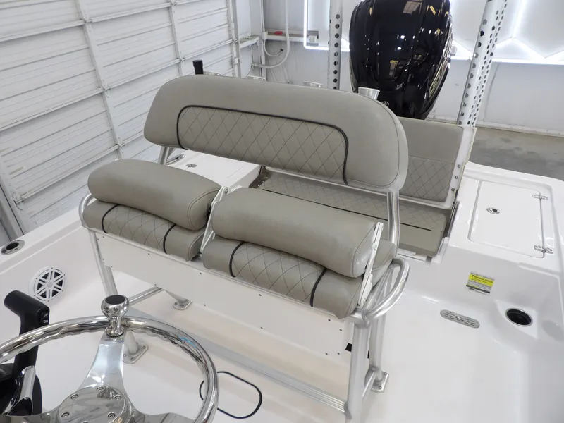 Slide: The Image of The image shows the cockpit of a 2022 Sportsman Tournament 214 Bay Boat with cushioned seating. - 14
