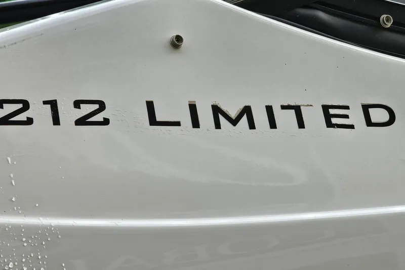 Slide: The Image of 2019 Yamaha Boats 212 Limited logo on white boat hull. - 30