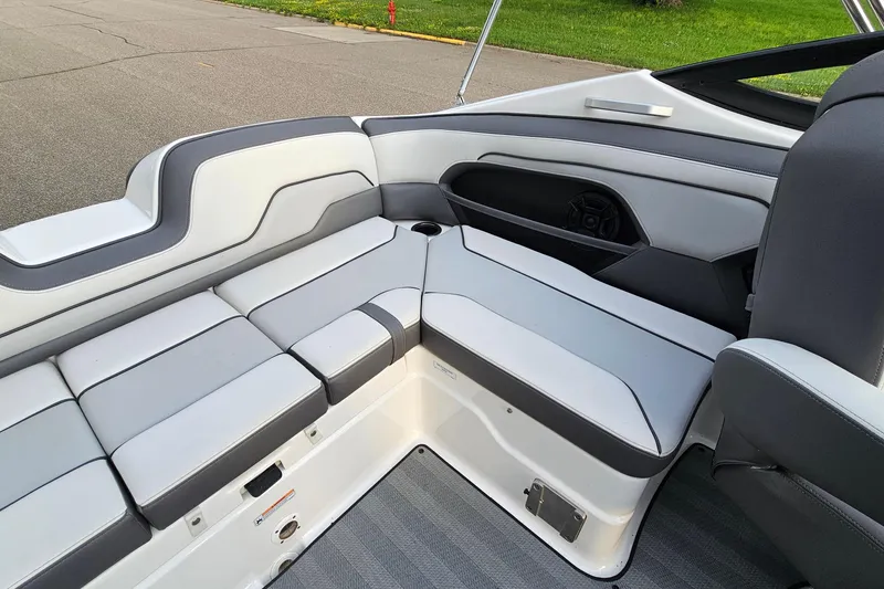 Slide: The Image of 2019 Yamaha Boats 212 Limited interior with sleek gray and white seating. - 9