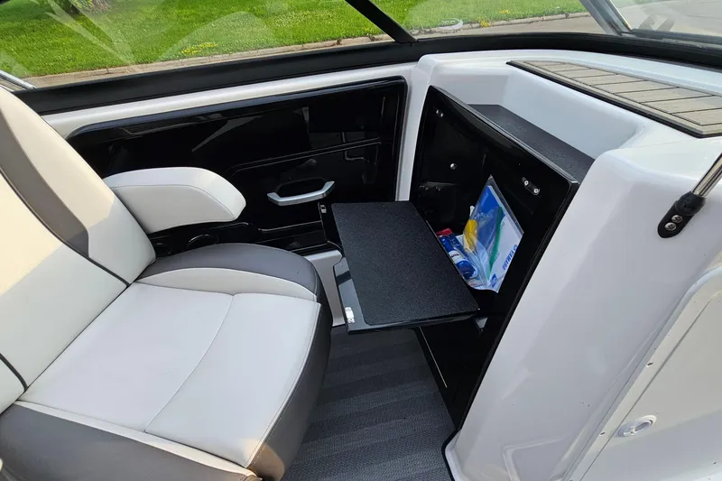 Slide: The Image of 2019 Yamaha Boats 212 Limited interior with seating and storage compartment. - 23
