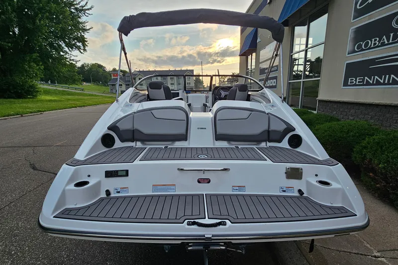 Slide: The Image of 2019 Yamaha Boats 212 Limited, rear view, docked with sunset in background. - 5