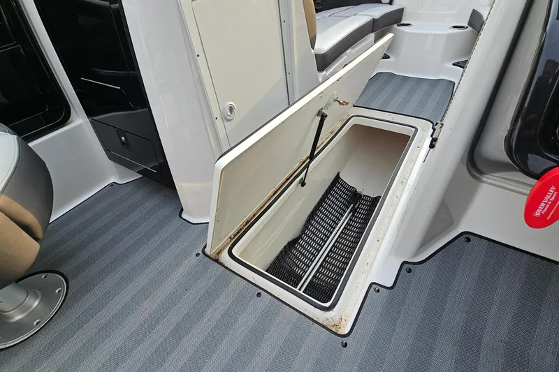 Slide: The Image of Open storage compartment on 2019 Yamaha Boats 212 Limited, featuring spacious interior and sleek design. - 20
