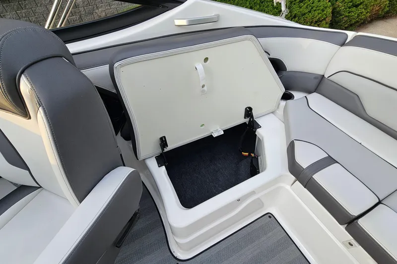 Slide: The Image of 2019 Yamaha Boats 212 Limited interior with open storage compartment. - 21