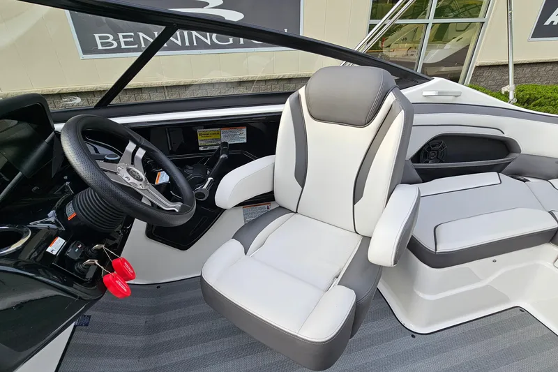 Slide: The Image of 2019 Yamaha Boats 212 Limited interior with steering wheel and seating. - 12