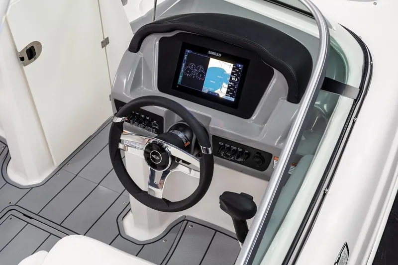 Slide: The Image of Manufacturer Provided Image: 2025 Chaparral 23 SSi boat dashboard with steering wheel and navigation display. - 4
