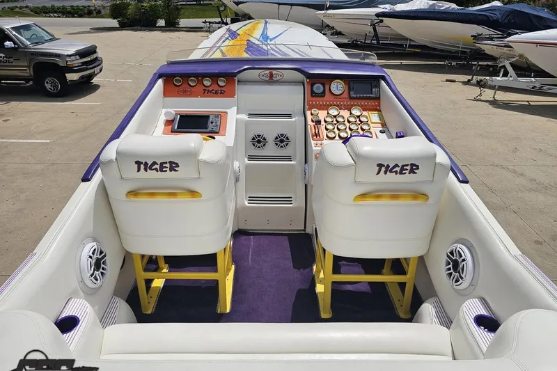 Slide: The Image of 2002 Cigarette 42' Tiger boat interior with dual seats and control panel. - 50