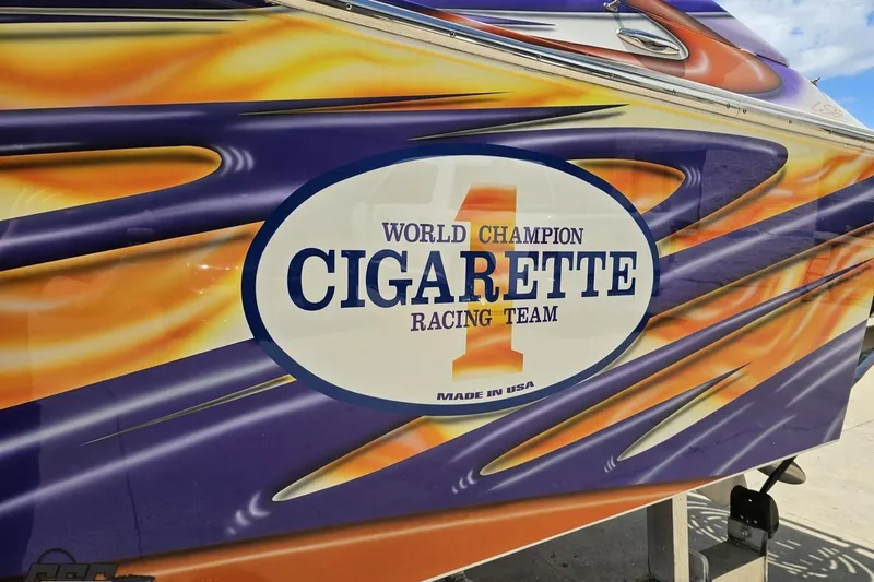 Slide: The Image of 2002 Cigarette 42' Tiger boat with vibrant racing graphics and "World Champion" logo. - 29
