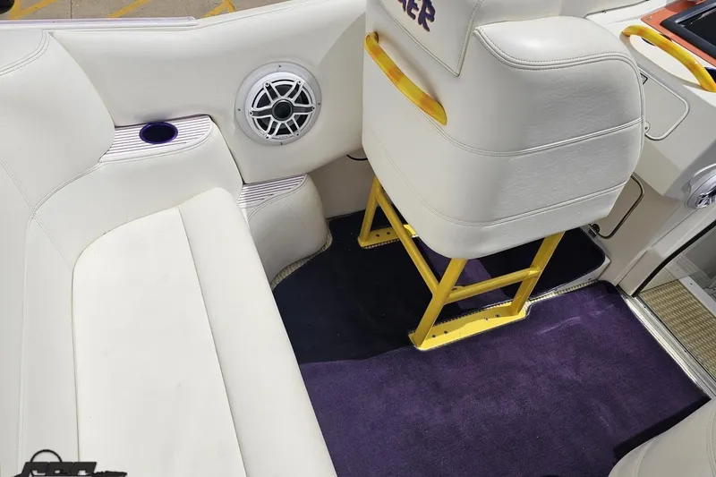 Slide: The Image of Interior of a 2002 Cigarette 42' Tiger boat with white seating and yellow accents. - 58