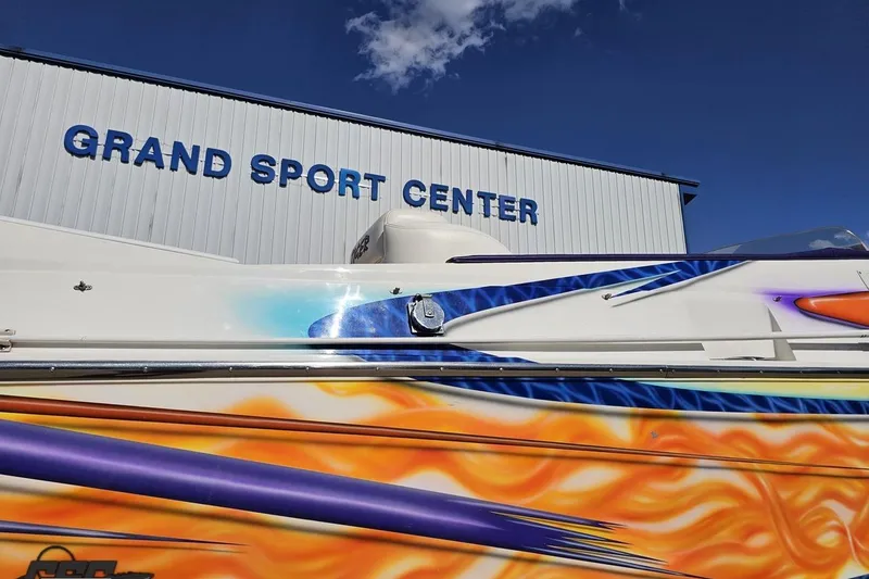 Slide: The Image of 2002 Cigarette 42' Tiger boat with vibrant graphics at Grand Sport Center. - 12