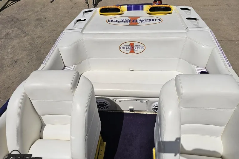Slide: The Image of 2002 Cigarette 42' Tiger boat interior with white leather seating and branded logo. - 72
