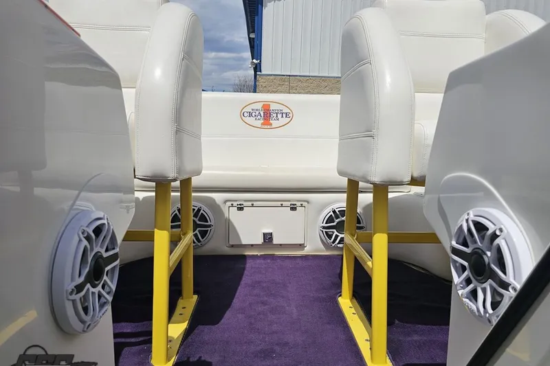 Slide: The Image of Interior of a 2002 Cigarette 42' Tiger boat with white seats and purple carpet. - 85