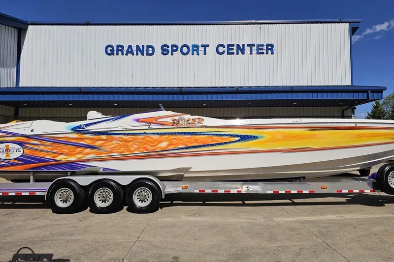 Slide: The Image of 2002 Cigarette 42' Tiger boat with vibrant graphics at Grand Sport Center. - 3