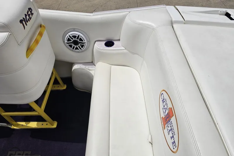 Slide: The Image of Interior of a 2002 Cigarette 42' Tiger boat with white seating and speaker. - 54