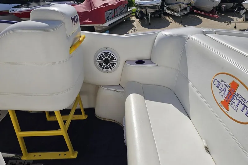 Slide: The Image of Interior of a 2002 Cigarette 42' Tiger boat with white seating and branded logo. - 56