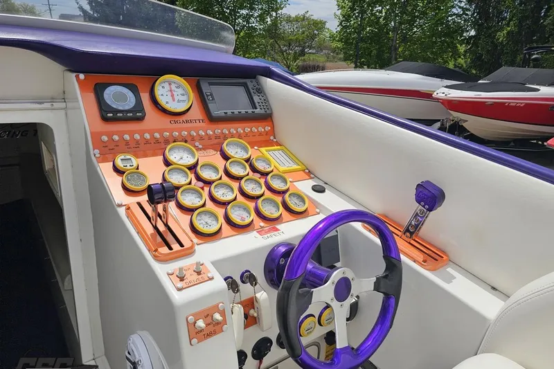 Slide: The Image of Dashboard of a 2002 Cigarette 42' Tiger boat with vibrant gauges and controls. - 64