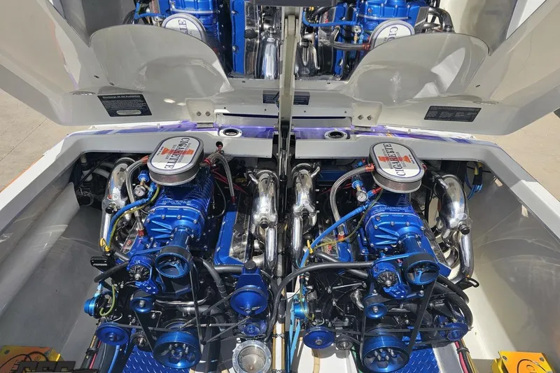 Slide: The Image of Twin engines of a 2002 Cigarette 42' Tiger boat, showcasing detailed mechanics. - 94
