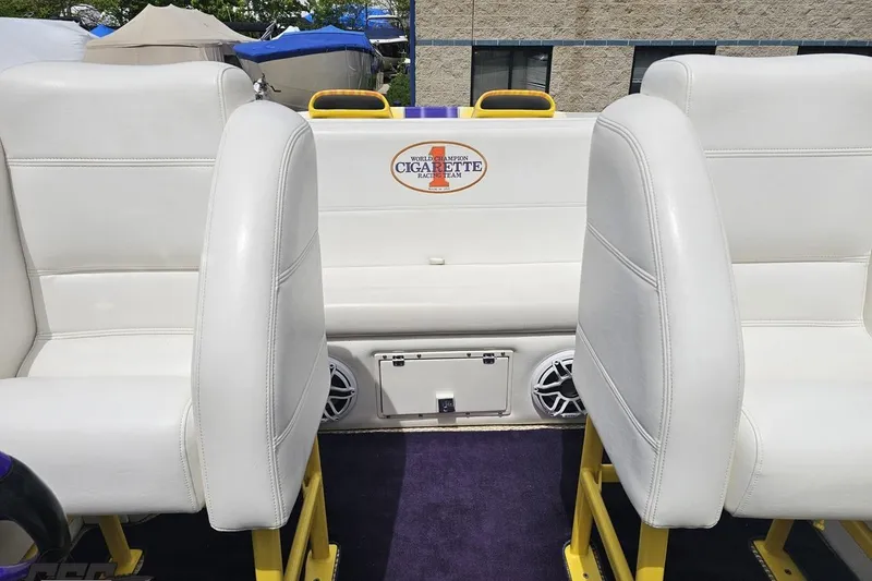 Slide: The Image of Interior of a 2002 Cigarette 42' Tiger boat with white seating and branded logo. - 86