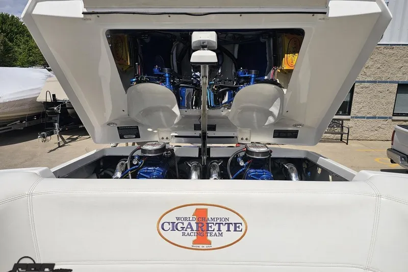 Slide: The Image of 2002 Cigarette 42' Tiger boat engine compartment with open hatch, showcasing powerful engines. - 93