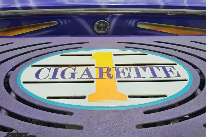 Slide: The Image of Cigarette 42' Tiger 2002 boat emblem with vibrant purple and yellow design. - 42